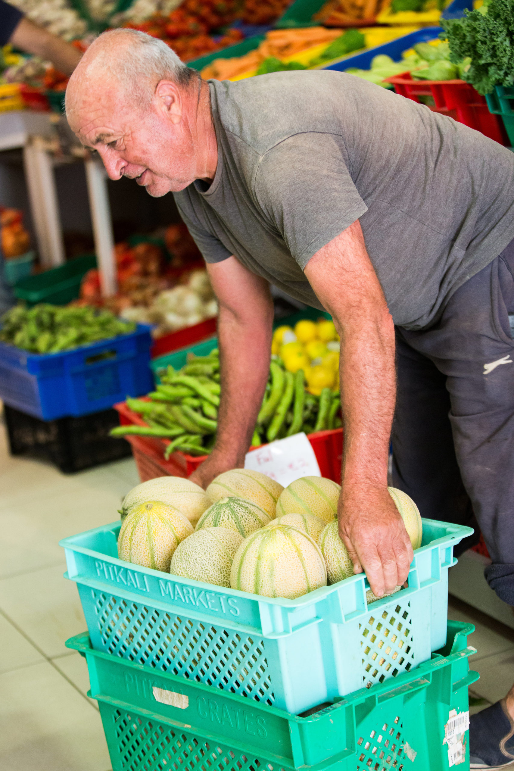 Big Fresh team member arranging fresh melons